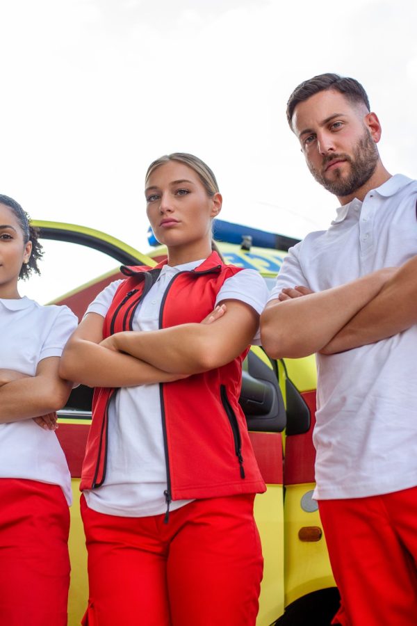 Multi-ethnic paramedics standing at the fromt of an ambulance. Emergency doctor and nurse standing in front of ambulance